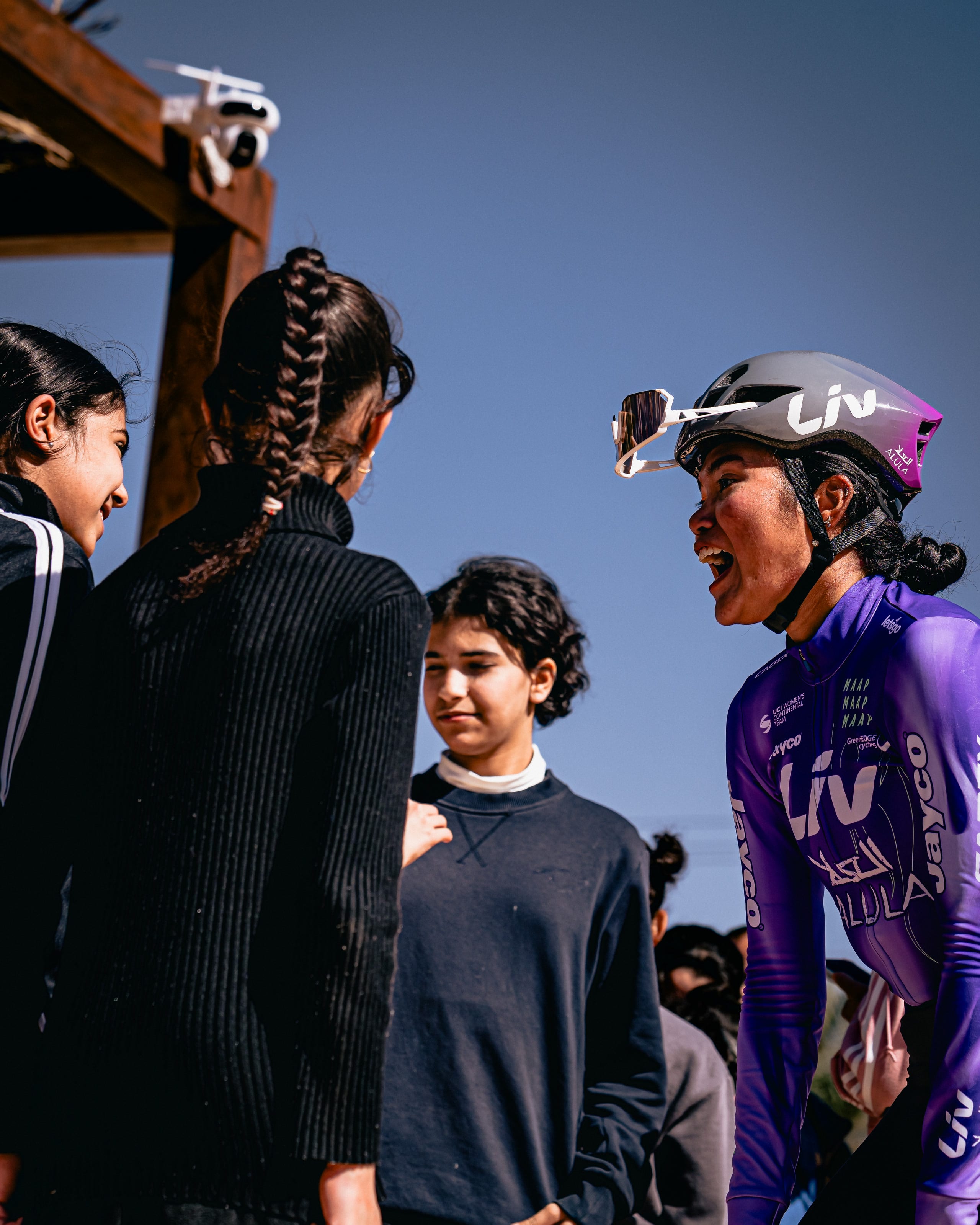Moroj Adil laughing with a group of teenage girls at a clinic in AlUla